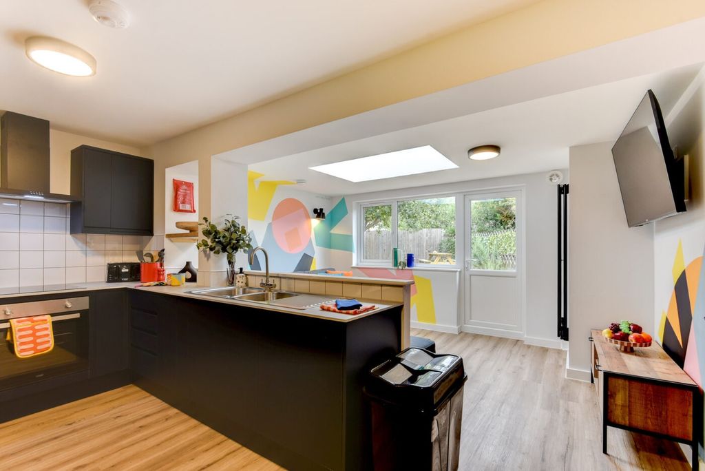 Property photo 1 of 6 Bright Modern Kitchen With Dark Cabinetry, A Break...