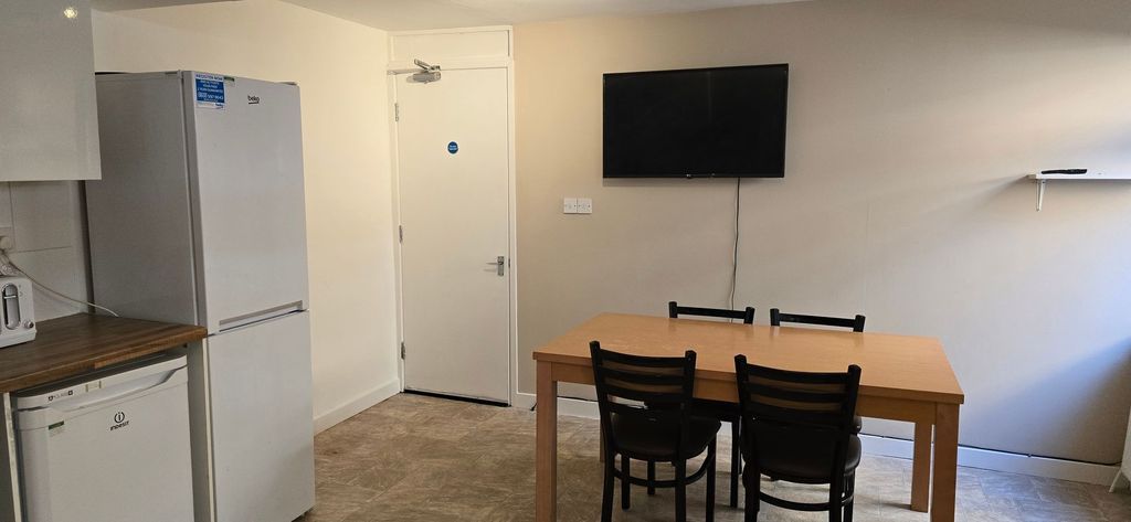 Property photo 3 of 8 Neutral Shared Kitchen/Dining Area With A Wooden T...
