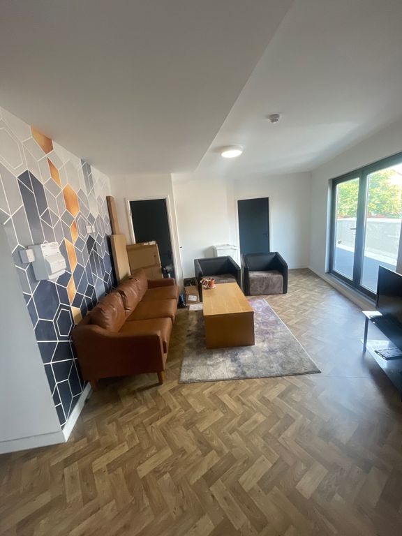 Property photo 2 of 12 A Modern Living Room Featuring Stylish Wooden Herr...