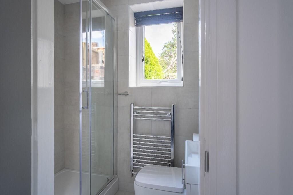 Property photo 2 of 12 A Clean, Well-Lit Bathroom Featuring A Toilet And ...