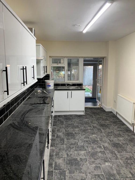 Property photo 2 of 6 Spacious Kitchen Featuring Sleek Black Countertops...