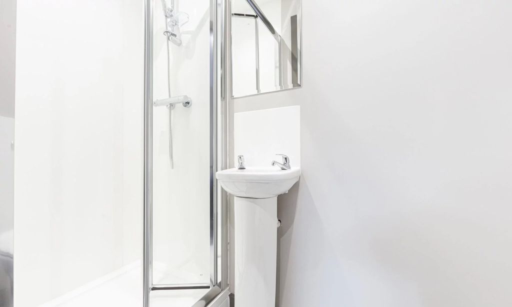 Property photo 3 of 4 A Modern And Pristine Bathroom Featuring A Sleek S...