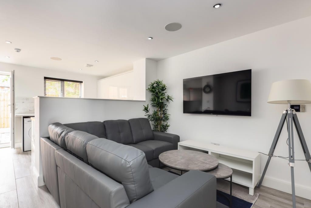 Property photo 2 of 14 A Modern And Inviting Living Room Featuring A Larg...