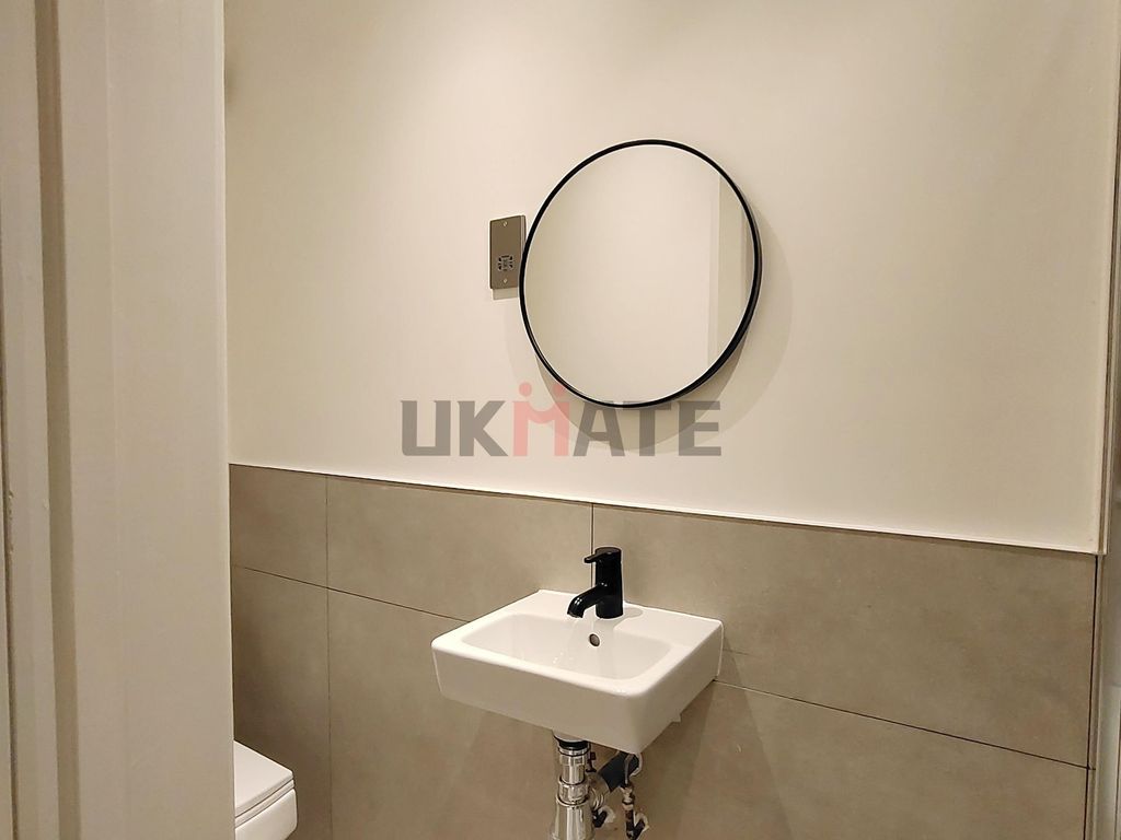Property photo 2 of 10 A Modern Compact Bathroom Featuring A Small Sink W...