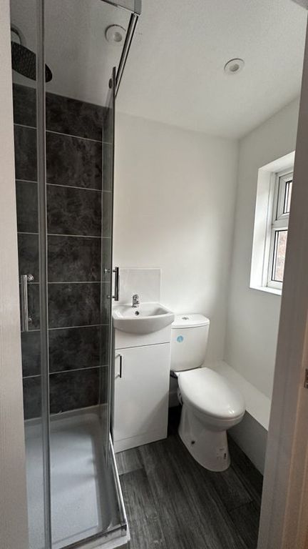 Property photo 3 of 7 Bright And Modern Bathroom Featuring A Sleek Showe...