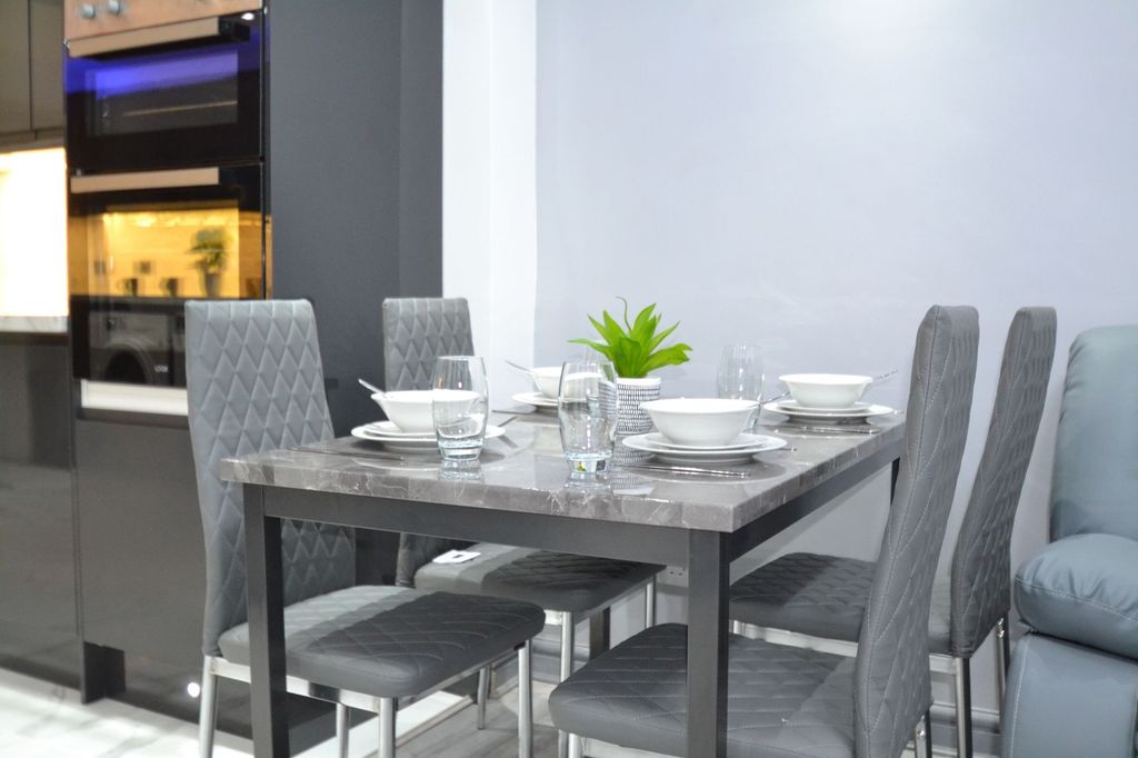 Property photo 3 of 30 Modern Dining Area With A Sleek Grey Marble-Top Ta...