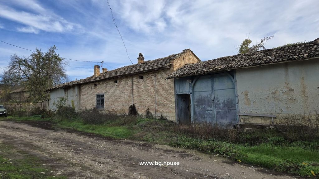 Property photo 3 of 53 Exterior View Of The Brick House With Chimneys And A Large Blue Wooden Gate Beside A Dirt Road