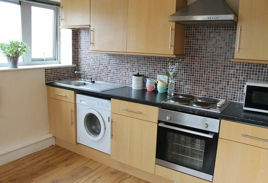 Property photo 3 of 3 This Modern Kitchen Features Sleek Cabinetry, Ampl...