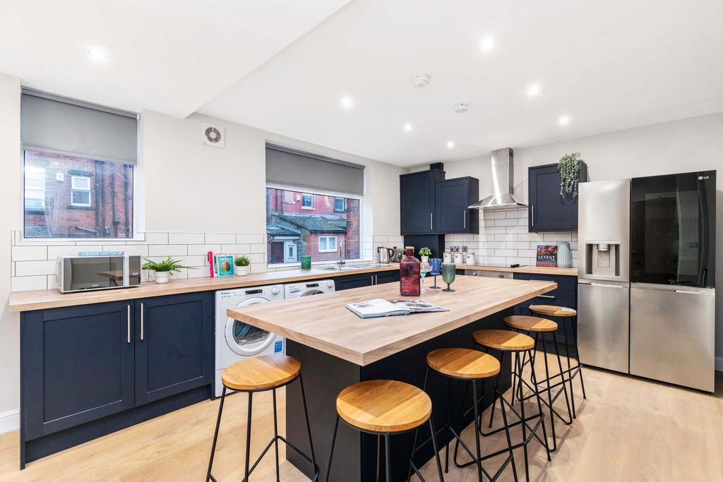 Property photo 1 of 15 A Modern, Bright Kitchen Featuring A Central Islan...
