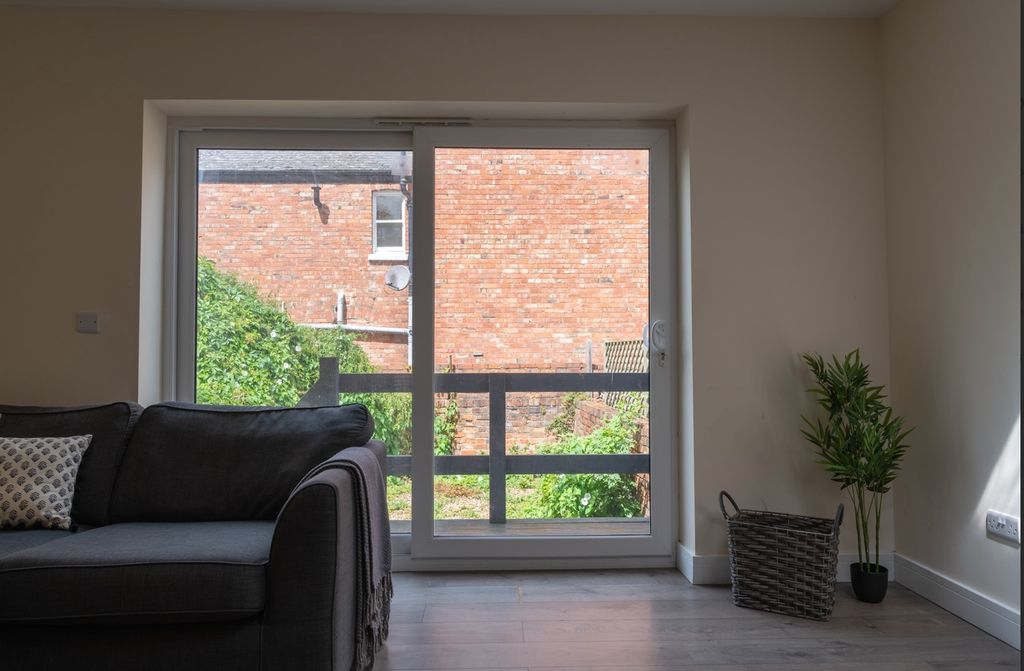 Property photo 2 of 15 Bright And Inviting Living Room Featuring Large Wi...