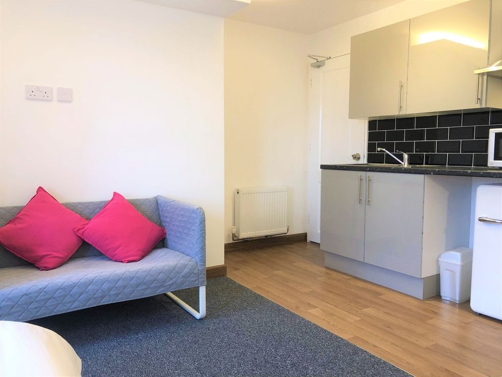 Property photo 3 of 6 Bright And Tidy Living Area Featuring A Modern Kit...