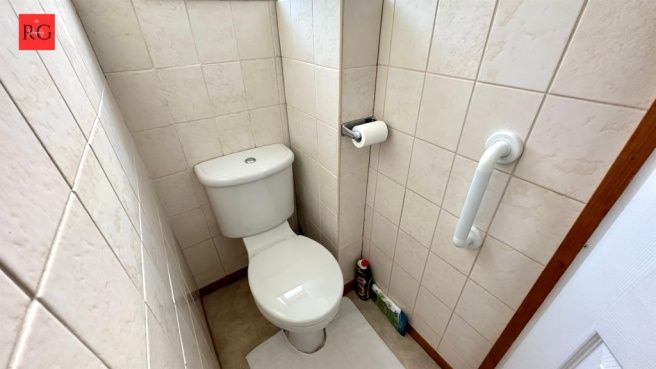 Property photo 2 of 15 Compact And Clean Single Toilet With Tiled Walls A...