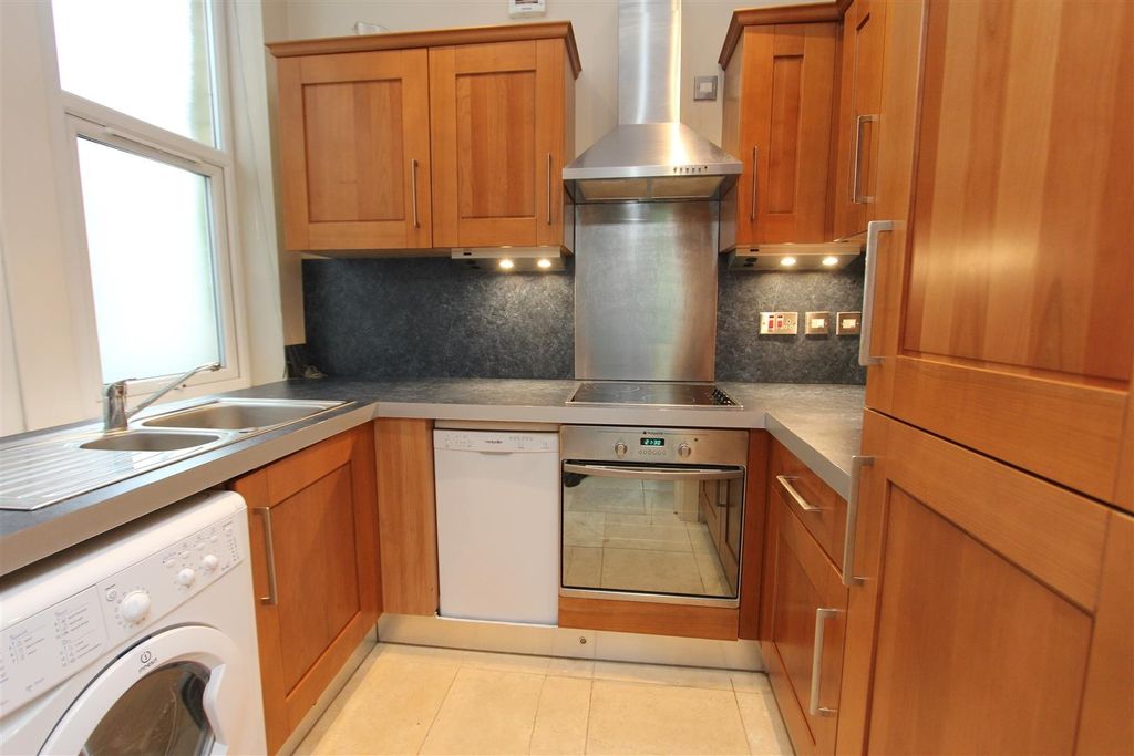 Property photo 2 of 8 Compact Kitchen With Wooden Units And Modern Oven...