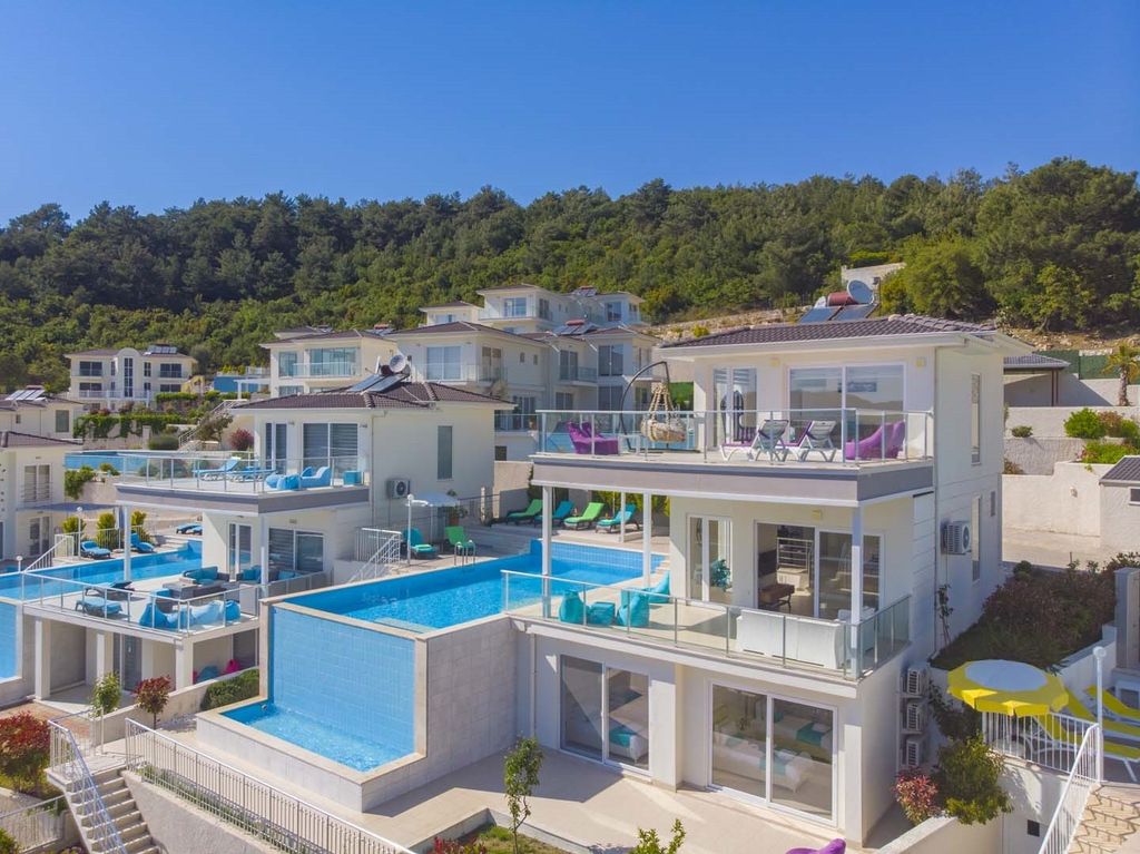 Property photo 1 of 24 A Glamorous 4-Bedroom Fethiye Property For Sale - Main View Of The Triplex Villa With Infinity Pool