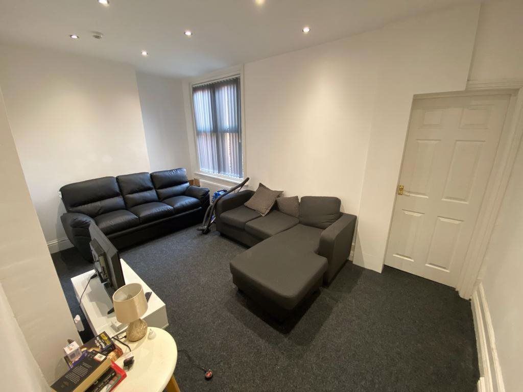 Property photo 2 of 25 A Spacious And Modern Living Room Featuring Comfor...