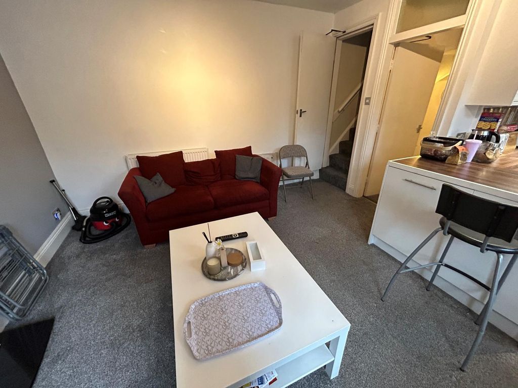 Property photo 1 of 9 A Comfortable Living Room Featuring A Red Sofa, A ...