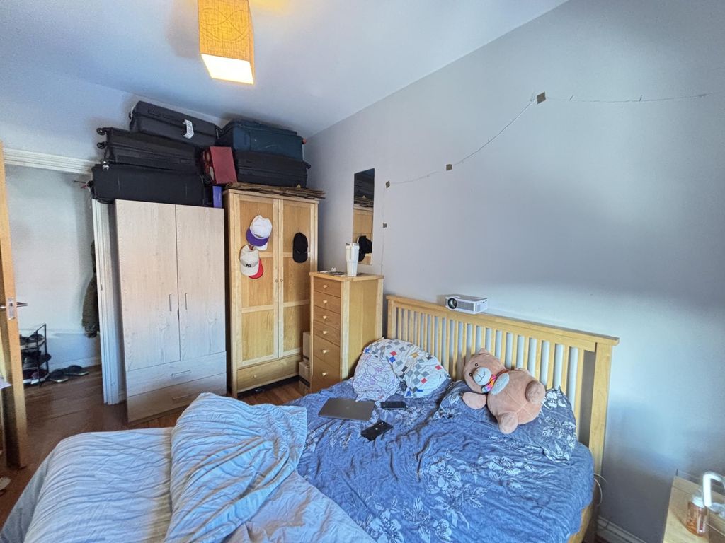 Property photo 2 of 7 A Cozy Bedroom Featuring A Bed With Plush Toys, A ...