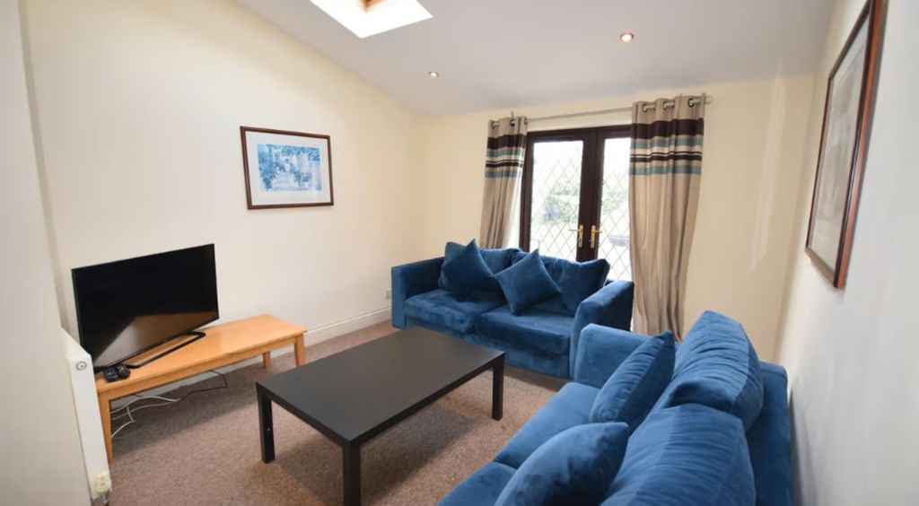 Property photo 3 of 16 Spacious And Inviting Living Room Featuring Comfor...