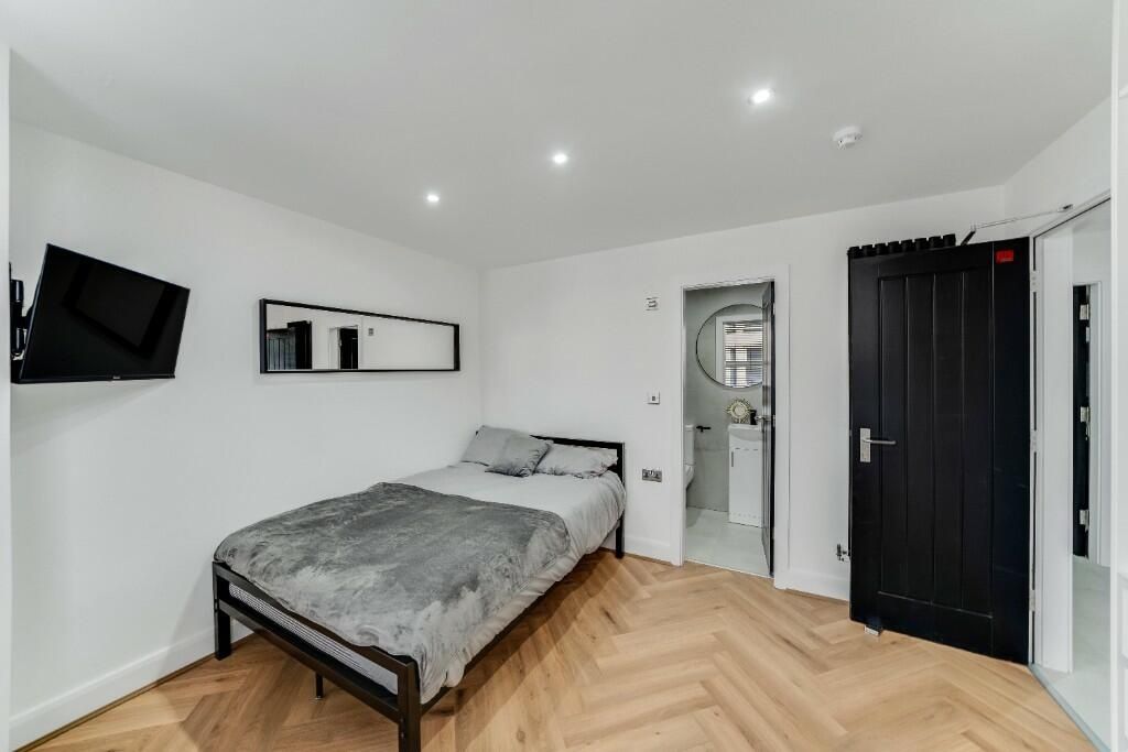 Property photo 3 of 14 A Modern, Well-Lit Bedroom Featuring A Double Bed,...