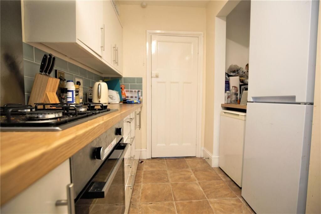 Property photo 3 of 14 A Neat And Modern Kitchen Featuring Wooden Counter...