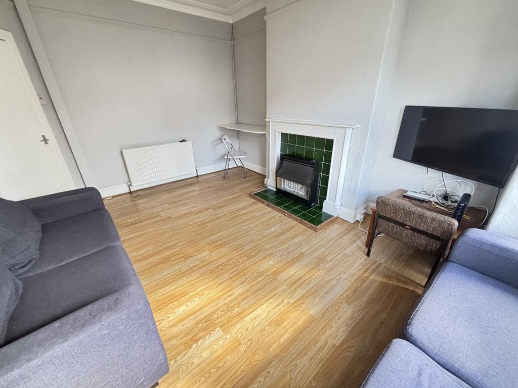 Property photo 2 of 12 A Bright And Welcoming Living Room Featuring A Com...