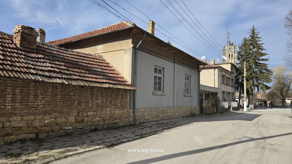 Property photo 3 of 52 Side Exterior View Of A Stone And Brick House With A Tiled Roof And An Adjacent Brick Wall Along The Street.