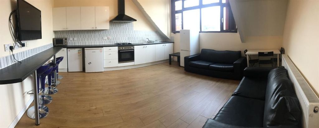 Property photo 1 of 13 A Modern And Spacious Living Room Featuring A Comf...