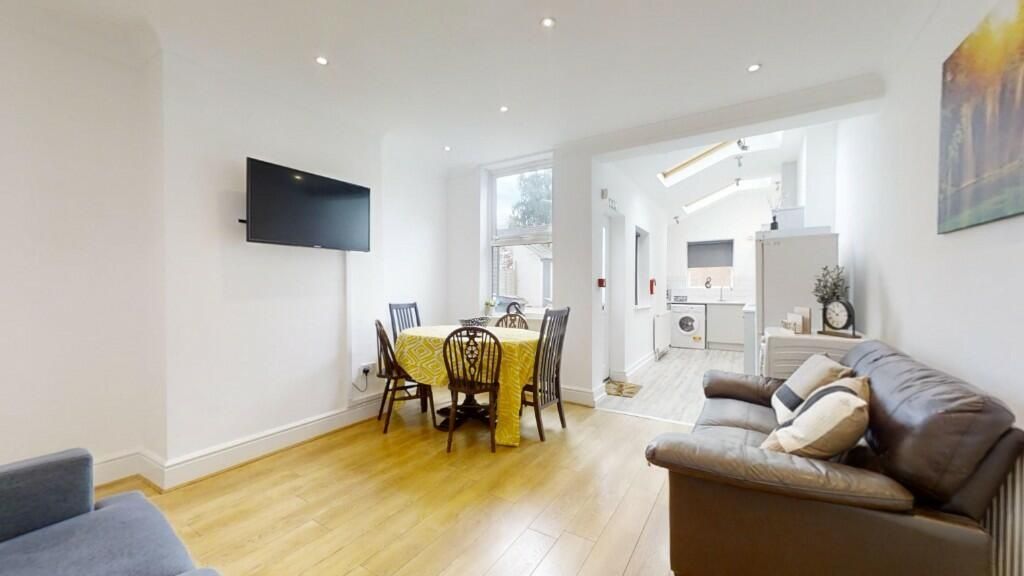 Property photo 3 of 13 Bright And Welcoming Living Room Featuring Modern ...