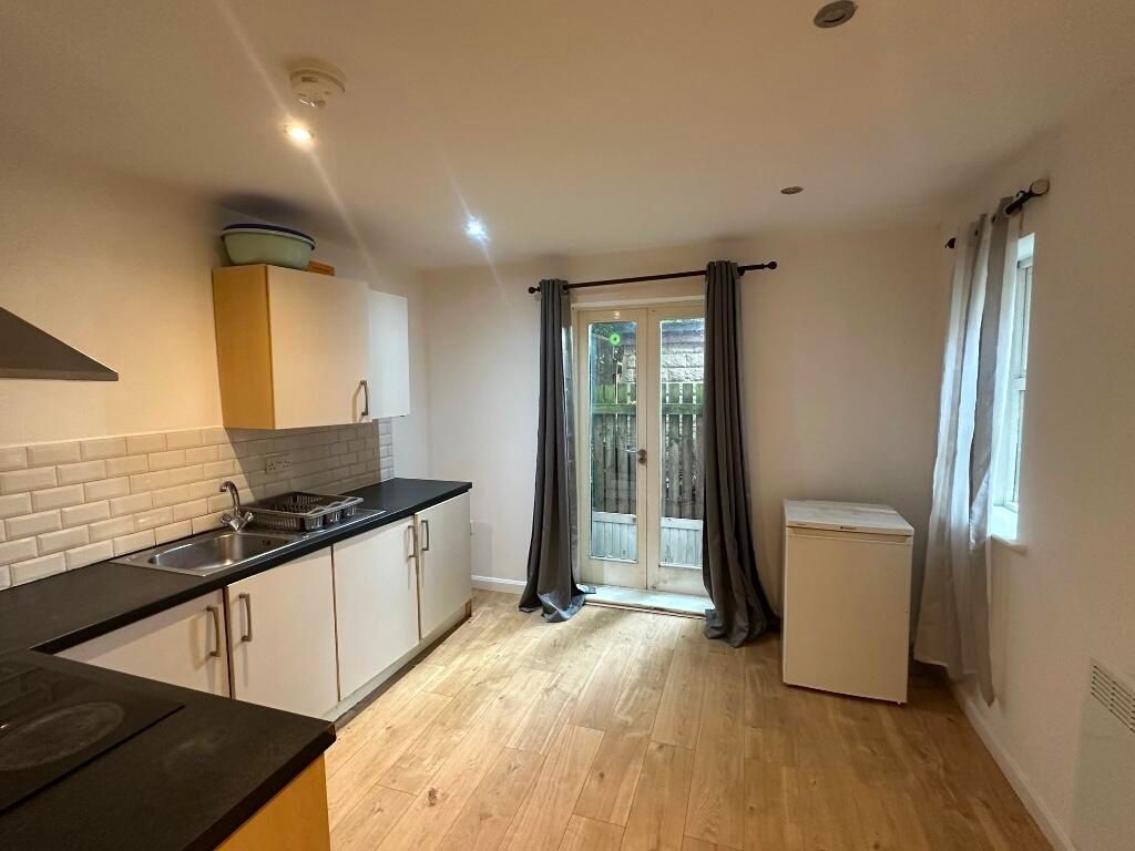 Property photo 2 of 6 Bright And Functional Kitchen Featuring Clean Tile...