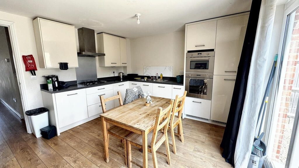 Property photo 3 of 6 Bright And Modern Kitchen Featuring A Spacious Woo...