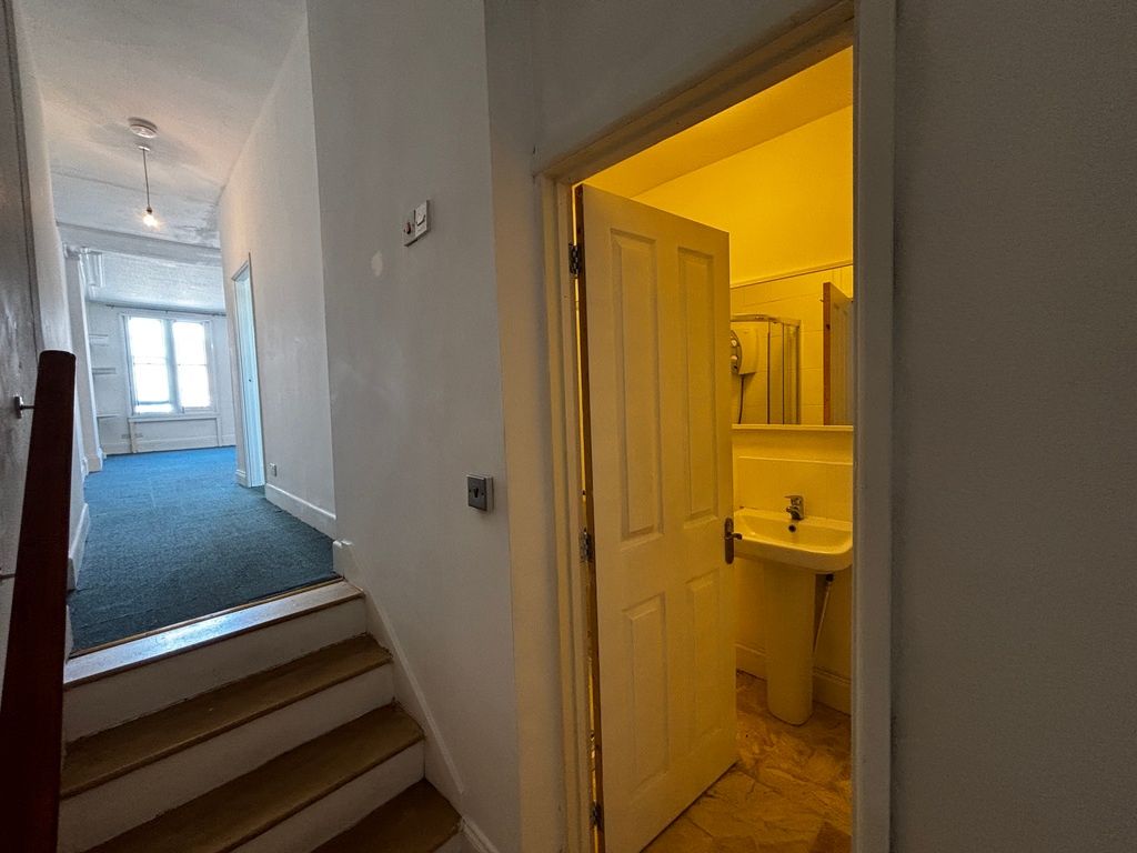 Property photo 1 of 8 Bright Hallway Leads To A Clean Modern Bathroom...