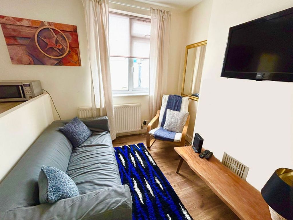 Property photo 2 of 8 This Inviting Living Room Features A Cozy Sofa, St...