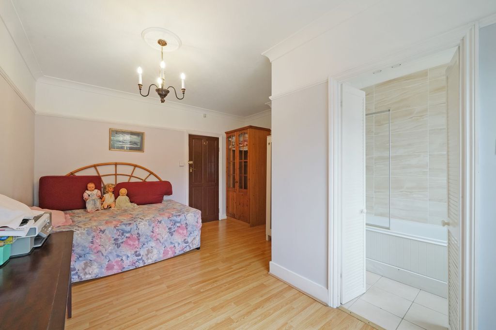 Property photo 2 of 15 A Spacious And Bright Master Bedroom Featuring Pol...