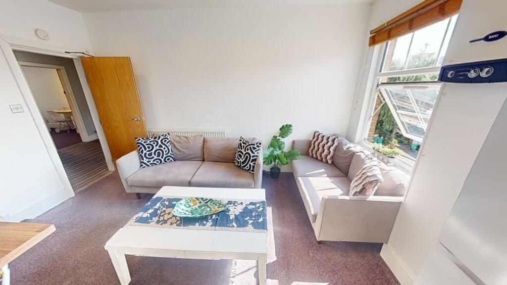 Property photo 3 of 11 Bright And Welcoming Living Room Featuring Two Com...