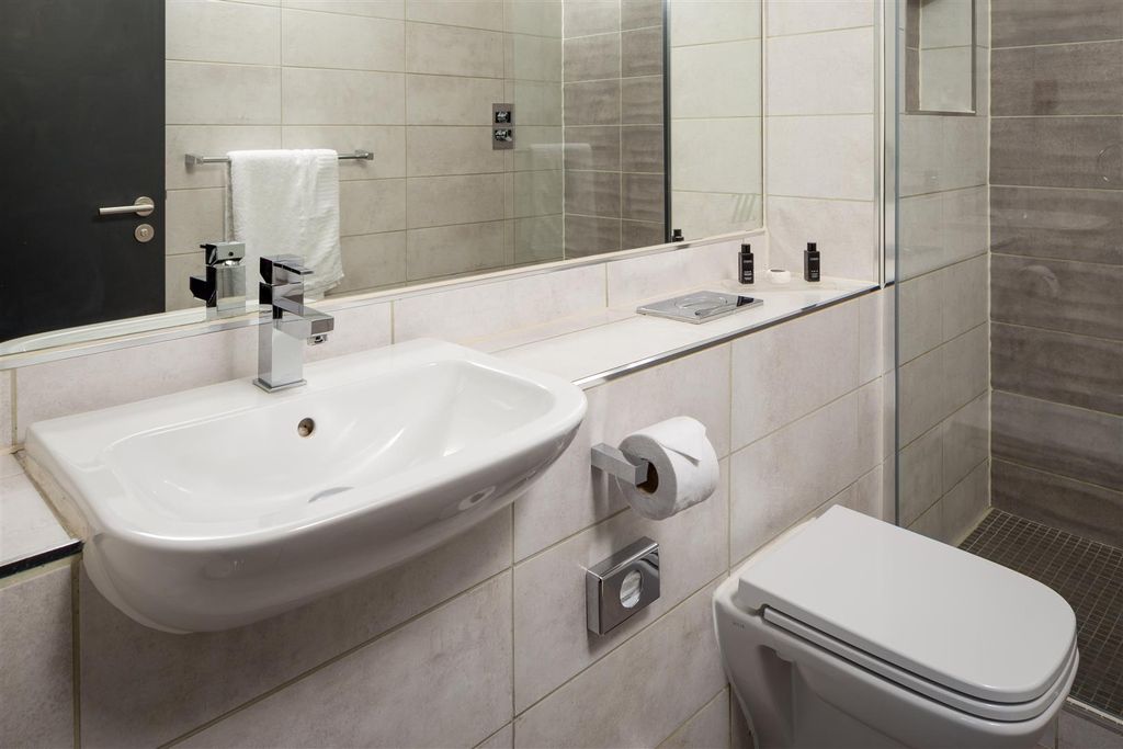 Property photo 3 of 6 Modern Tiled Bathroom With A Wall-Mounted Sink, La...