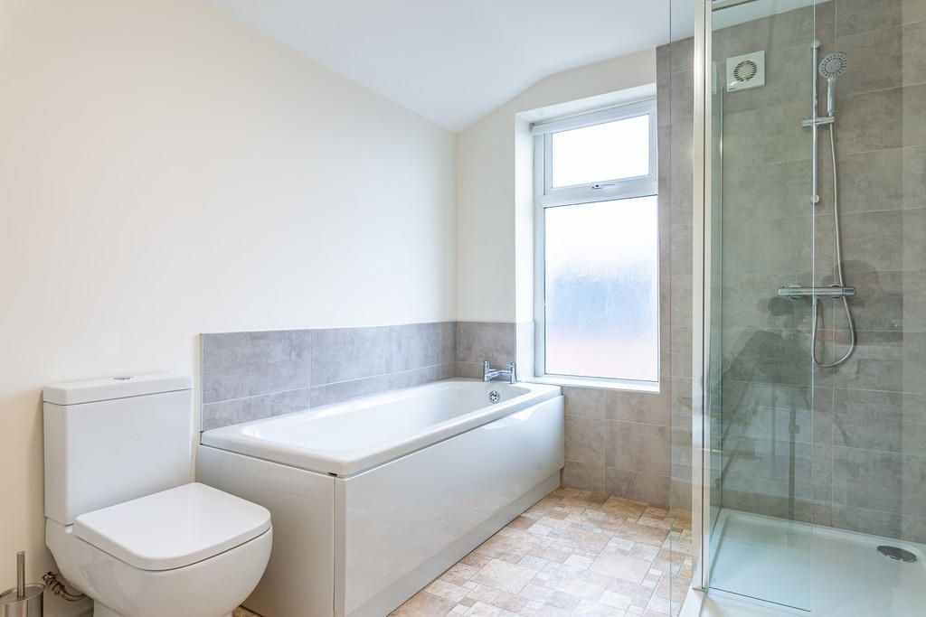 Property photo 2 of 9 Bright And Modern Bathroom Suite Featuring A Large...