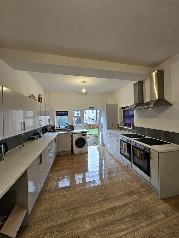 Property photo 2 of 3 Bright And Spacious Kitchen Featuring Sleek White ...