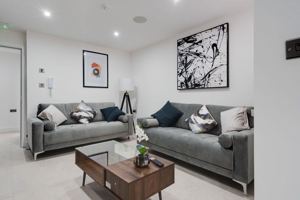 Property photo 2 of 10 Contemporary And Stylish Living Room Featuring Two...