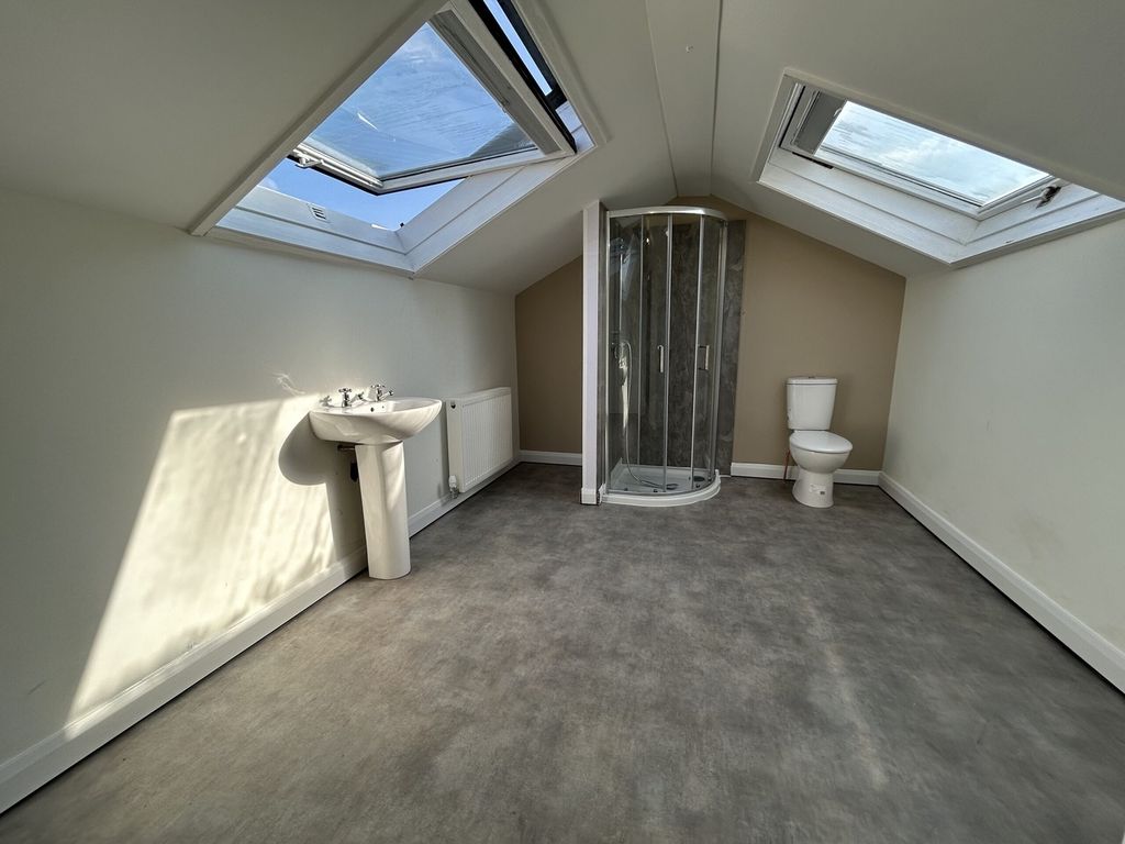 Property photo 3 of 15 A Spacious And Bright Bathroom Featuring Modern fi...