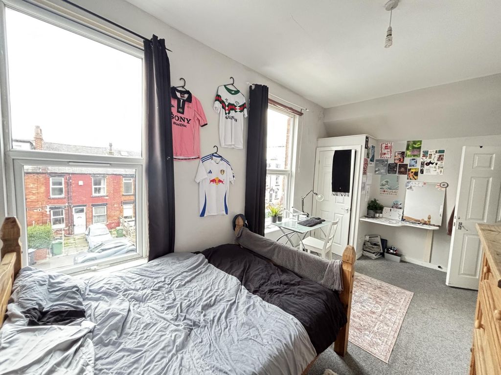 Property photo 3 of 29 A Cozy Bedroom Featuring A Double Bed With A Playf...