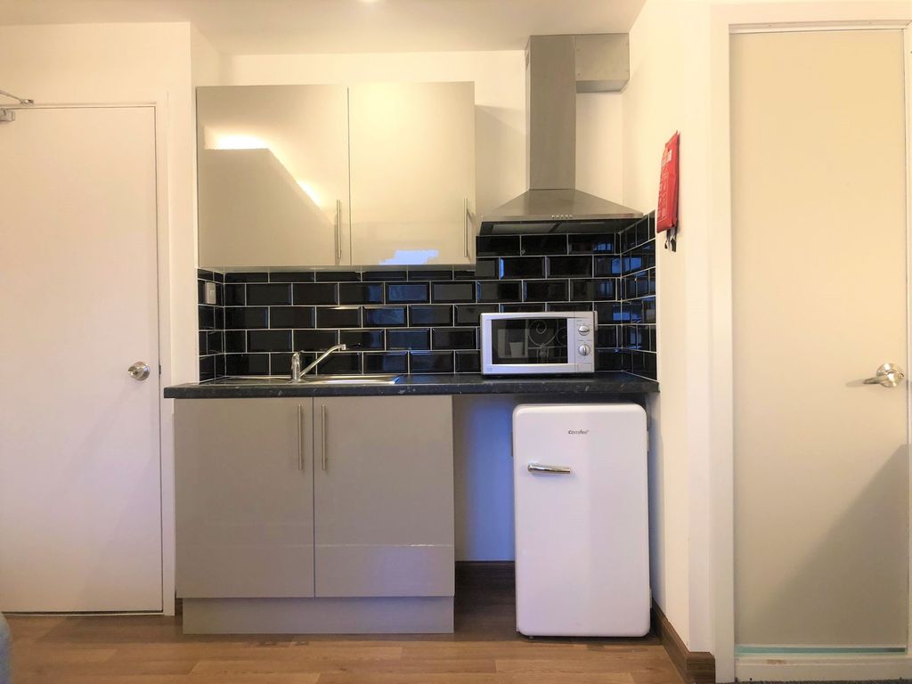 Property photo 3 of 5 A Modern Compact Kitchen Featuring Sleek Grey Cabi...