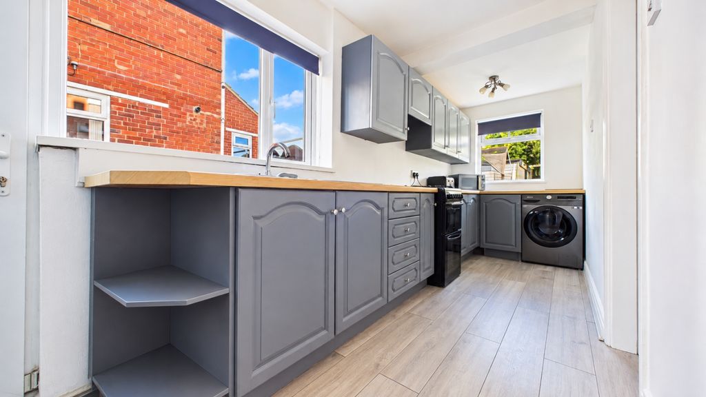 Property photo 3 of 11 Bright Tidy Gray Galley Kitchen