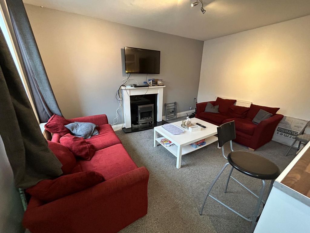 Property photo 2 of 9 A Spacious And Well-Lit Living Room Featuring Comf...