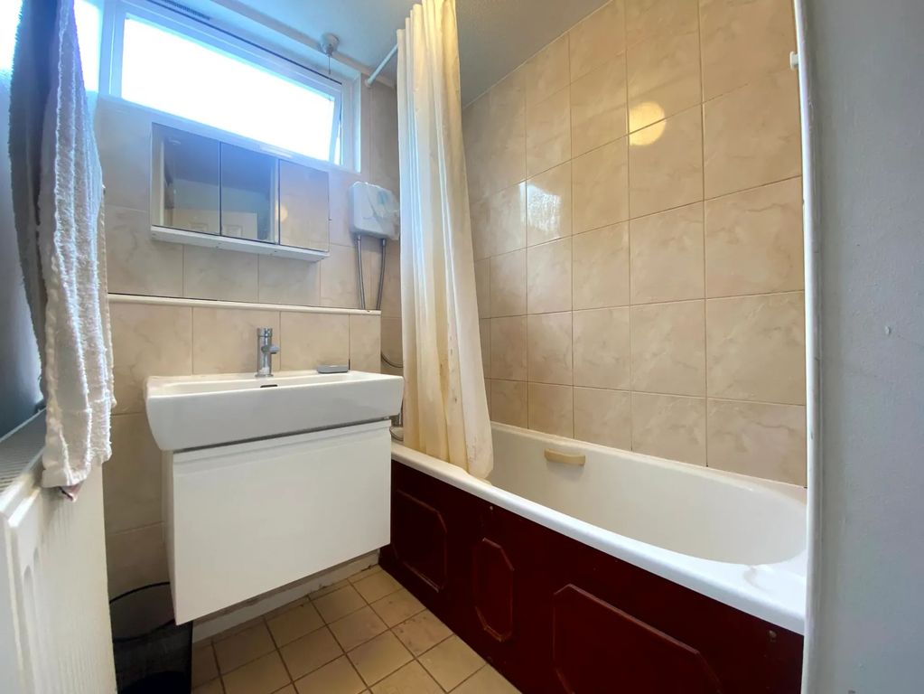 Property photo 3 of 8 A Well-Lit Bathroom Featuring A Clean White Sink A...