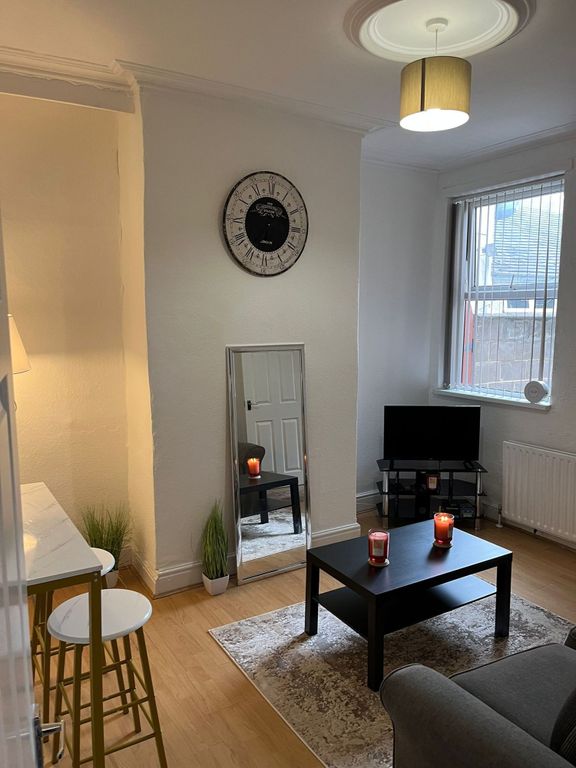 Property photo 2 of 7 Bright And Welcoming Living Room Featuring A Large...