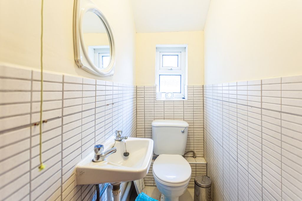 Property photo 2 of 14 This Cozy Single Toilet Features A Clean And Tidy ...