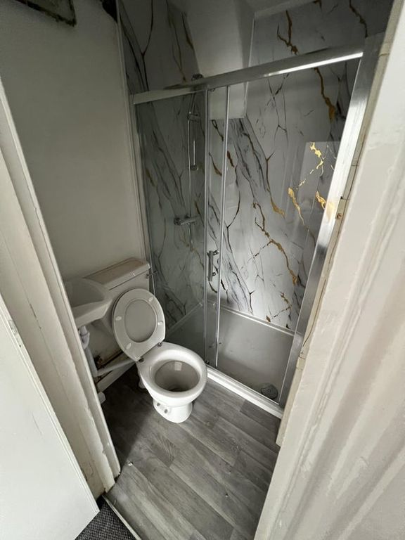 Property photo 1 of 4 A Compact Bathroom Featuring A Modern Framed Glass...