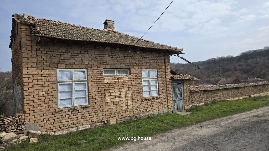 Property photo 3 of 94 Side Perspective Of A Brick House With White-Framed Windows, Tiled Roof, And A Garden Wall Extending Along A Dirt Road