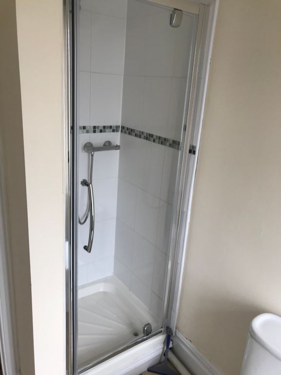 Property photo 3 of 12 A Modern Bathroom Featuring A Sleek Shower Enclosu...