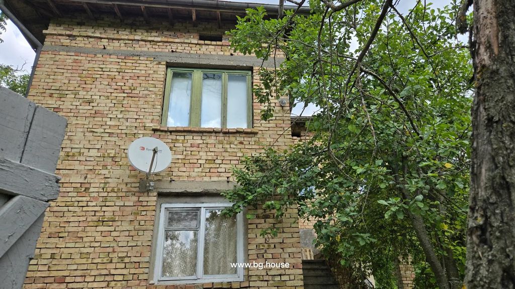 Property photo 2 of 53 Side View Of Two-Story Brick House With Green Window Frames, Satellite Dish, And Trees Around.